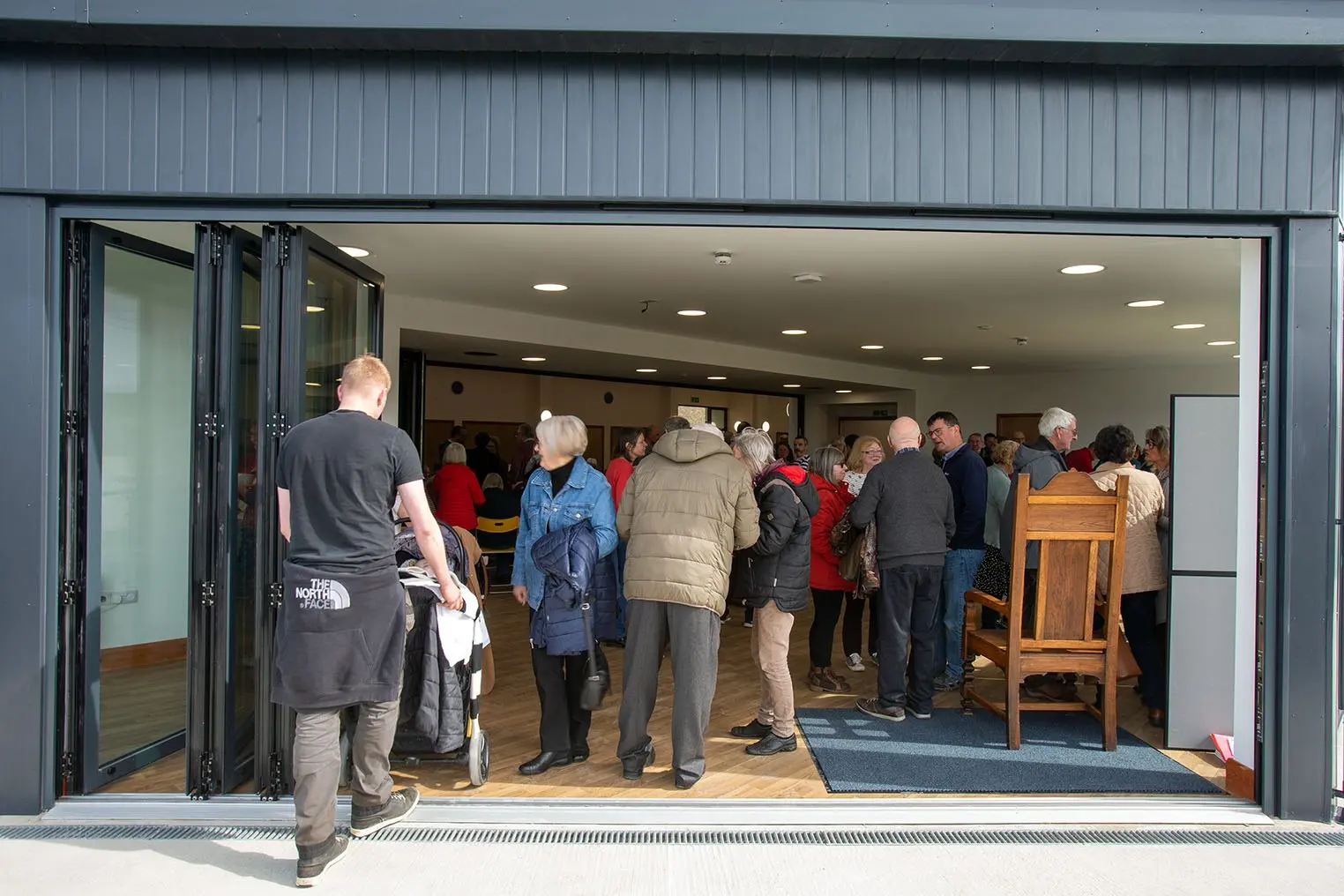 Visitors arriving through the open bi-fold doors during an event