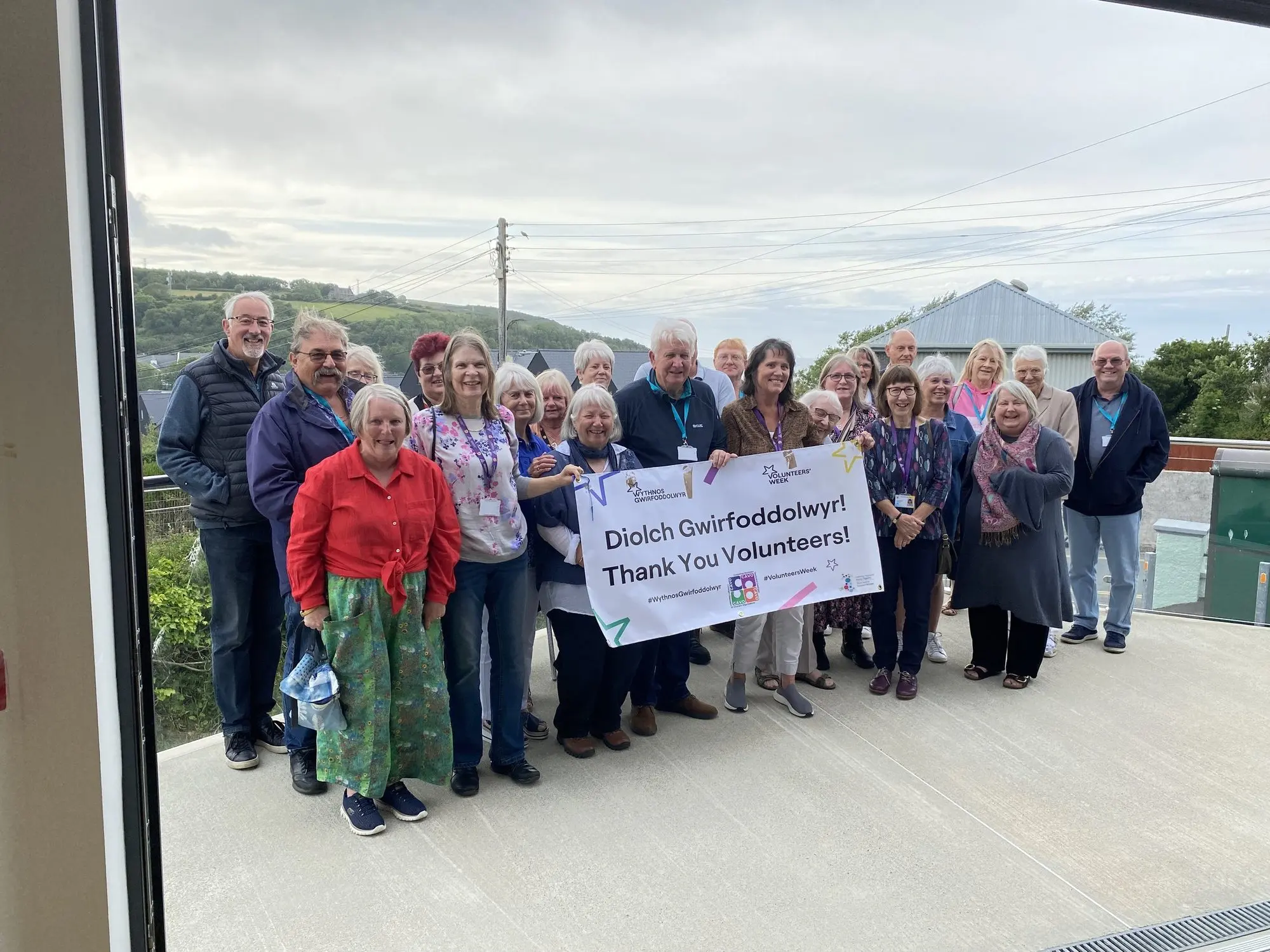 Hall volunteers with a thank-you banner